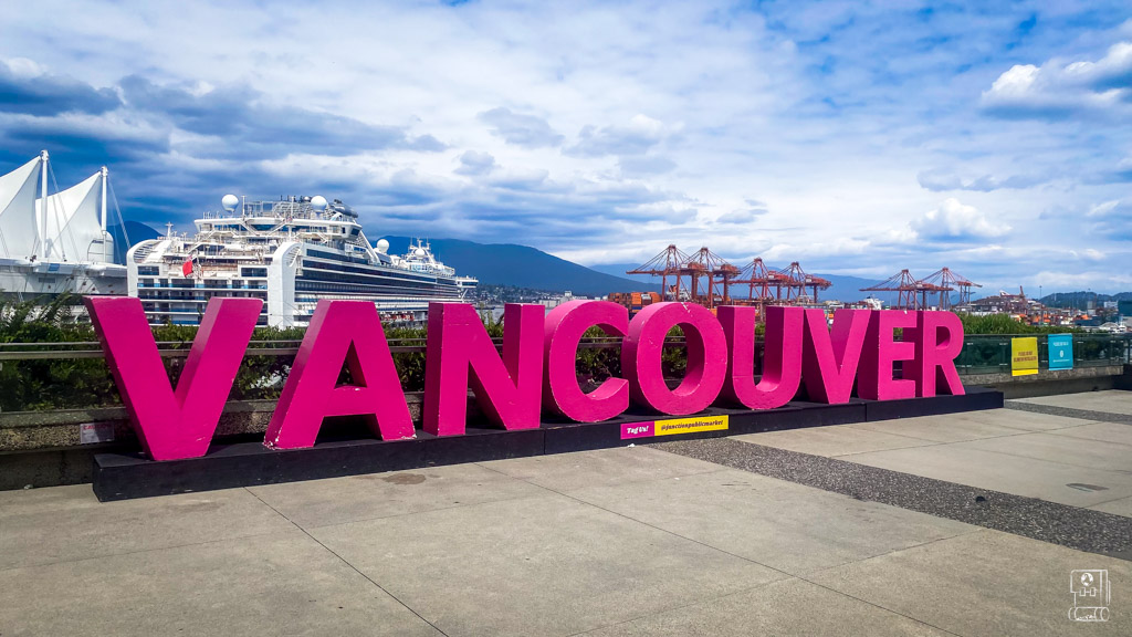 Vancouver sign at Canada Place waterfront showing cruise ship terminal near downtown hotels